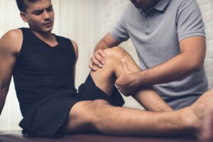 therapist treating injured knee